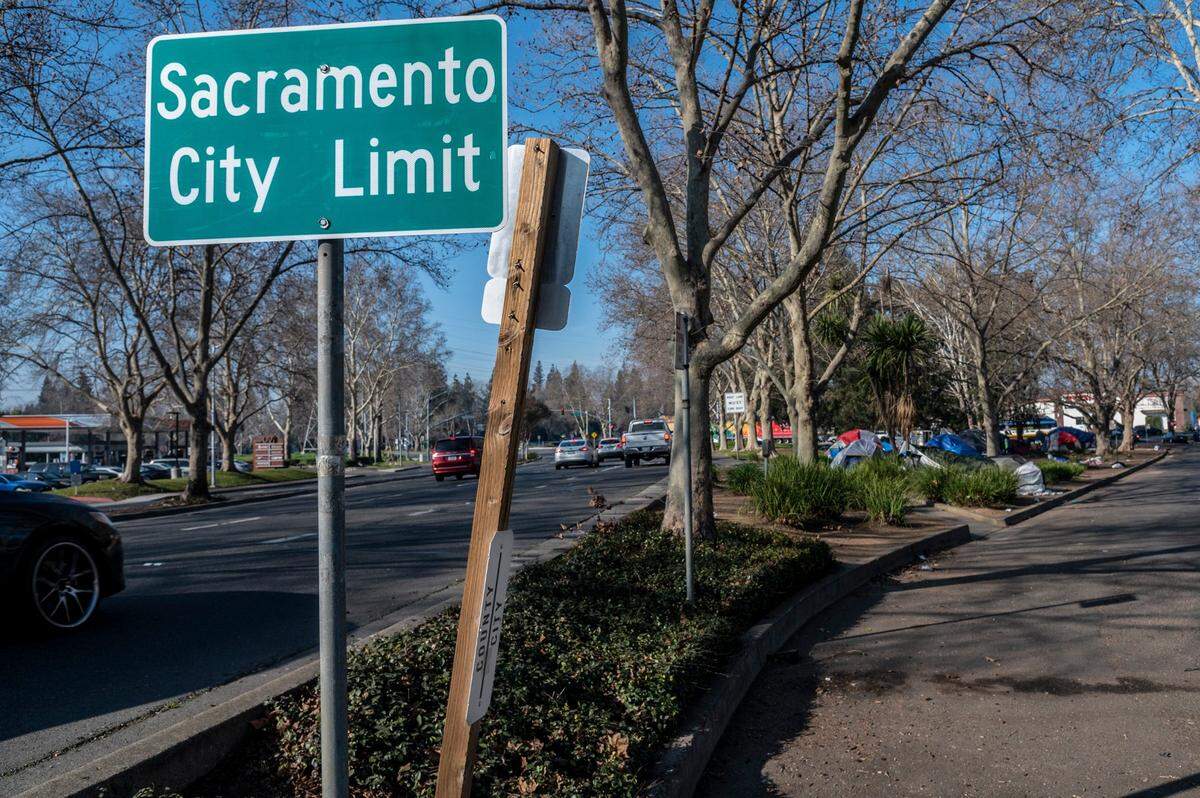 A sign clearly shows that a homeless encampment on the corner of Fair Oaks Boulevard and Howe Avenue is inside city limits. Now it appears the District Attorney’s and Sheriff’s offices are preparing to file a lawsuit against the city over the encampment.