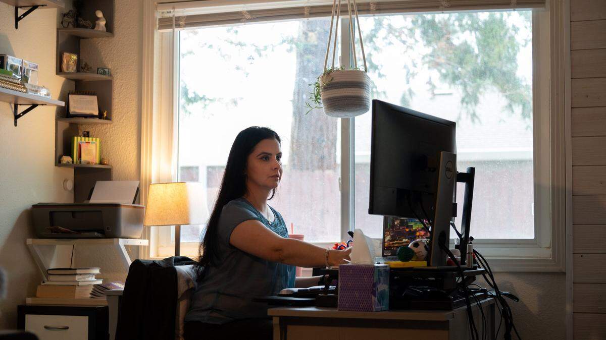 Department of General Services employee Monica Hassan telecommutes from her home office on Thursday, Nov. 18, 2021, in Sacramento. California’s army of state workers said in an informal survey by The Sacramento Bee that the price for in-office mandates are lost time, money and progress toward carbon emissions reduction goals.