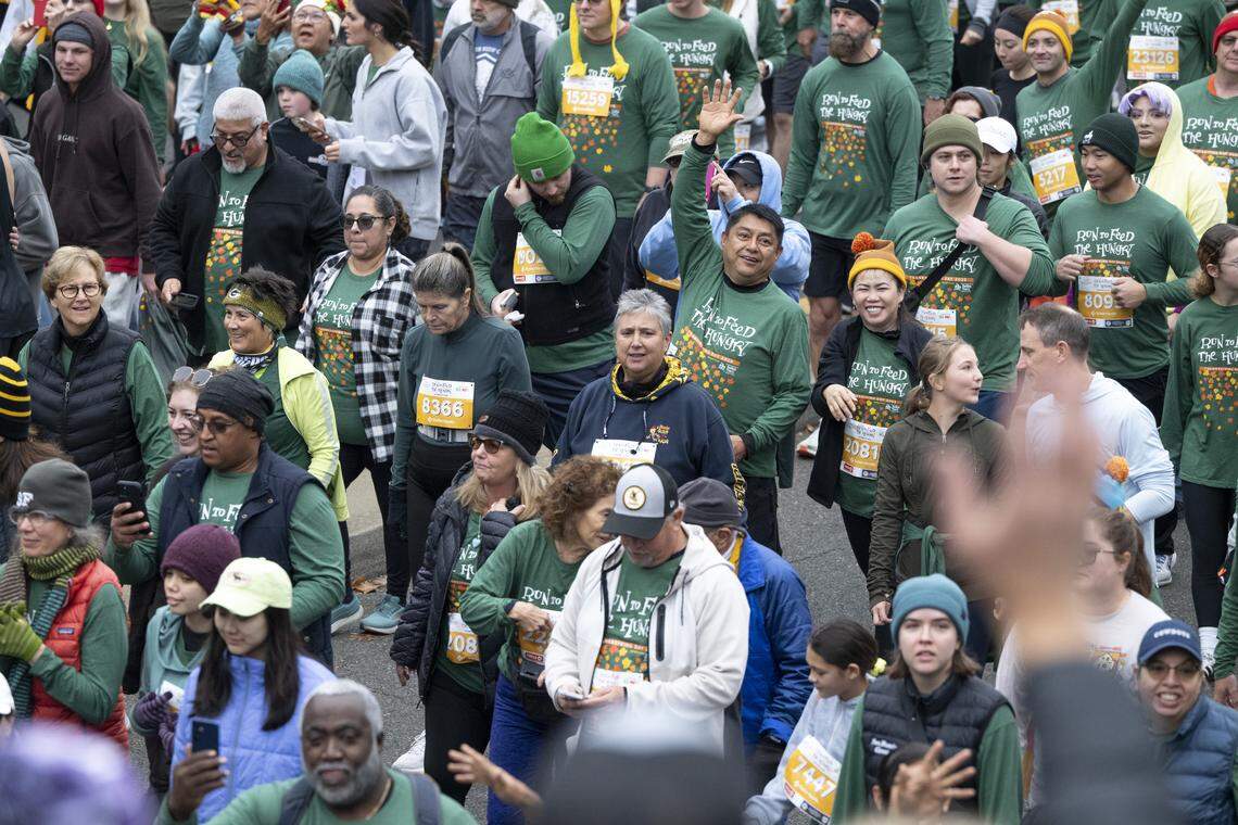 Race participants wave to the crowd during the Run to Feed the Hungry in Sacramento on Thursday, Nov. 27, 2025.