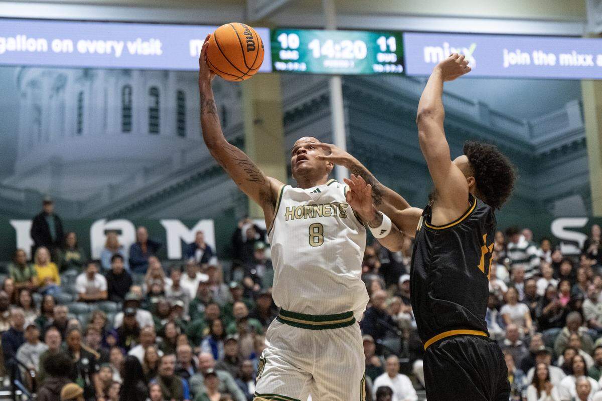 Sacramento State Hornets forward Shaqir O'Neal drives to the basket against Dominican Penguins guard Austin Johnson during a game at the Hornet Pavilion on Tuesday in Sacramento.