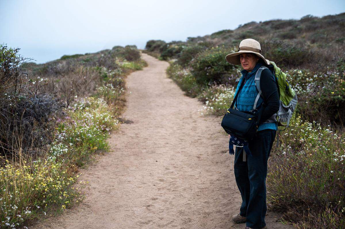Laura Chariton, president of the Watershed Alliance of Marin, hikes at the elk reserve on Tuesday. Chariton is suing the National Park Service over the herd’s health.