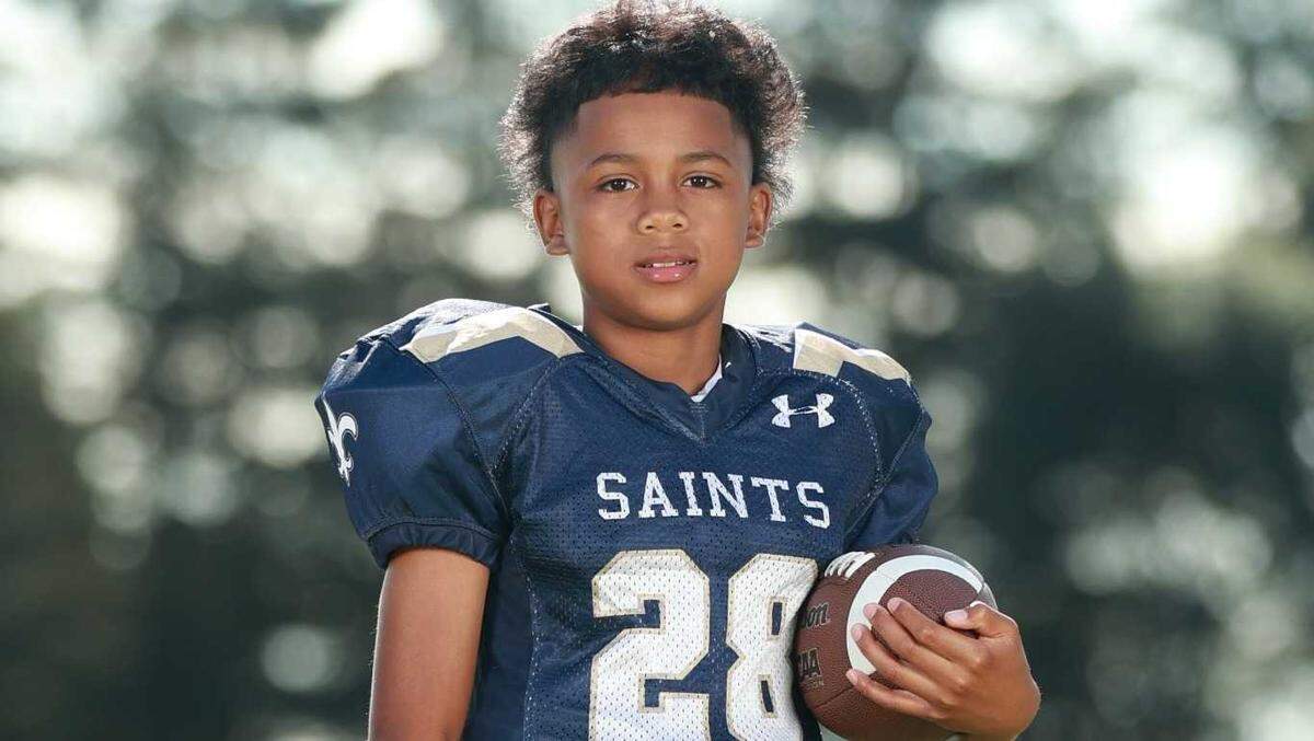 Amari Peterson is pictured in his football uniform. The 14-year-old honor roll student from Modesto was remembered as a gifted athlete with a smile that “would light the sky.”