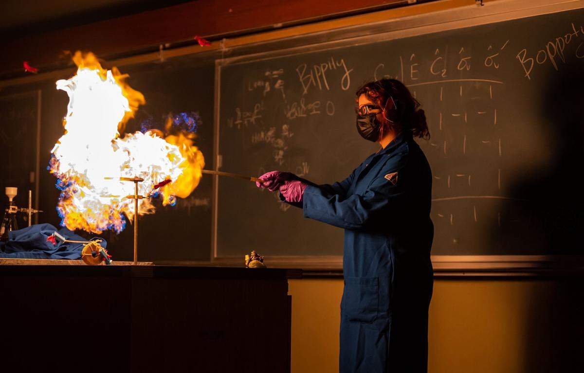 UC Davis student Tanya Herrera ignites a gas to demonstrate combustion during the Picnic Day chemistry show Saturday.