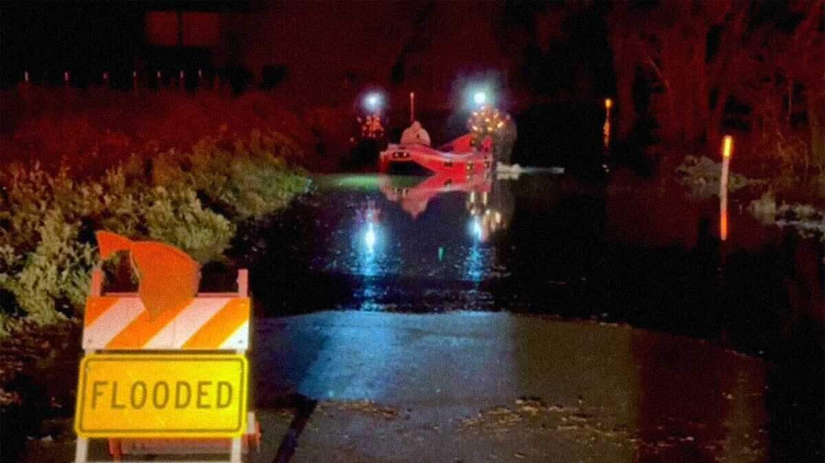 Rescuers shepherd a man from floodwaters using a rescue boat on Kiefer Road just south of Grant Line Road in southeastern Sacramento County on Tuesday, Feb. 16, 2026. Sacramento Metropolitan Fire District crews reached the man after his car was overtaken by water up to 5 feet deep when he drove around road closure signs.