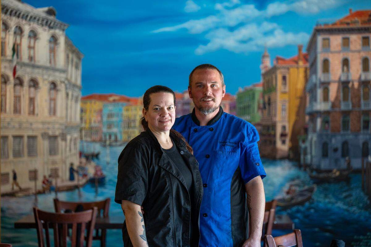 Nickolas and Sabrina Ippolito, owners of Ippolito’s Trattoria, stand in front of a mural at the Rosemont restaurant earlier this month. Bee readers voted the trattoria the region’s most underrated Italian restaurant.