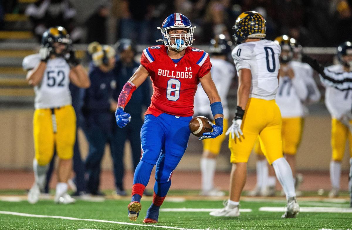 The Folsom Bulldogs’ Elijah Gulewich (8) celebrates a fumble recovery in the first half of the CIF Sac-Joaquin Section Division I football championship game against the Oak Ridge Trojans on Friday at Hughes Stadium.