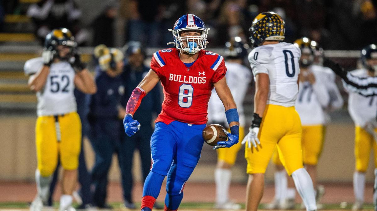The Folsom Bulldogs’ Elijah Gulewich (8) celebrates a fumble recovery in the first half of the CIF Sac-Joaquin Section Division I football championship game against the Oak Ridge Trojans on Friday at Hughes Stadium.
