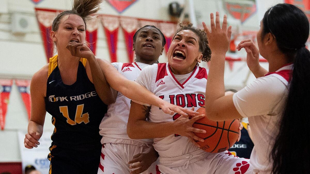 McClatchy Lions Samaya Beatty drives to basket defended by Oak ridge Trojans Megan McConnell during a playoff game at McClatchy High School on Monday, Feb 24, 2020 in Sacramento.
