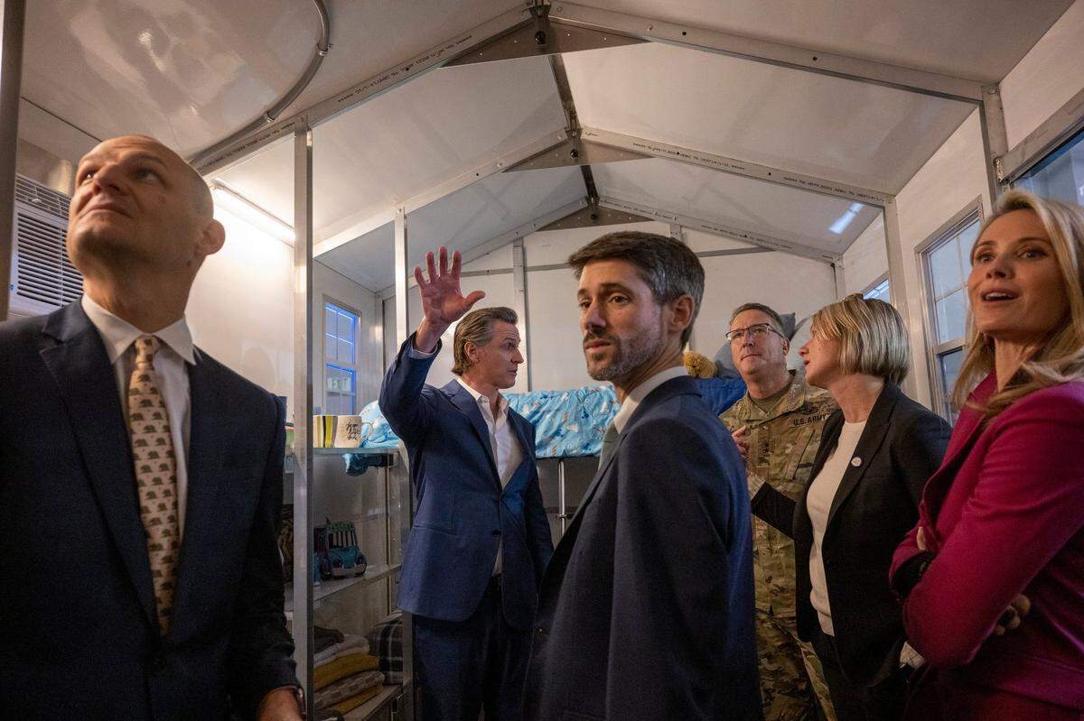 Gov. Gavin Newsom, center back, tours a tiny home with up front Assemblymember Kevin McCarty, San José Mayor Matt Mahan and First Partner Jennifer Siebel Newsom after he announced Thursday during a press conference that the state will have 1,200 tiny homes built and delivered throughout California in an effort to help house the homeless population.