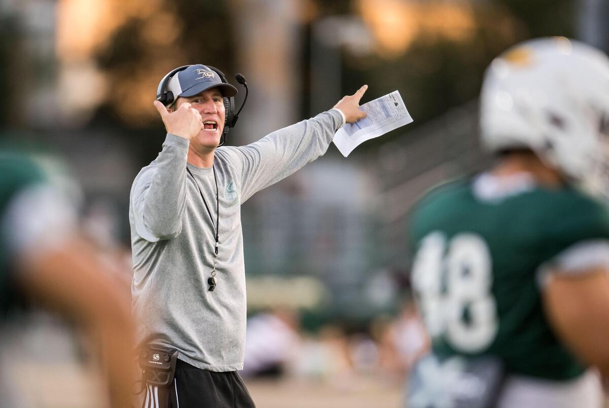 Sacramento State football head coach Andy Thompson communicates with his players during a scrimmage earlier this month at Hornet Stadium.