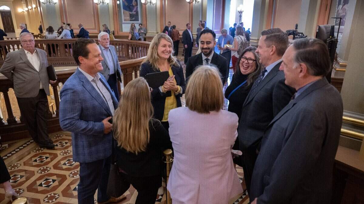 Assemblywoman Buffy Wicks, center, D-Oakland, speaks with lobbyists and another legislator during a break in the floor session at the state Capitol on Tuesday.