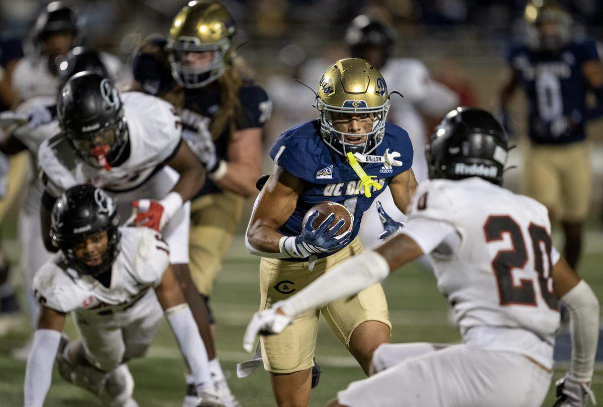 UC Davis Aggies running back Carter Vargas splits through the Southern Utah Thunderbirds defense for a touchdown in the second half on Saturday in Davis.
