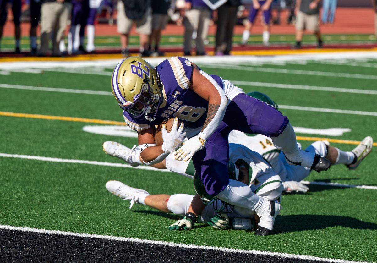 The Bradshaw Christian Pride’s Mateo Mojica (8) scores his team’s first touchdown as the Sonora Wildcats’ Cash Byington (7) and Jonathan Curran (14) defend in the Sac-Joaquin Section Division VI championship game at Hughes Stadium in Sacramento on Friday, Nov. 29, 2024.