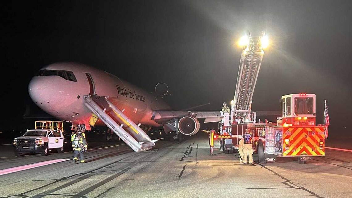 Firefighters are seen on the tarmac of Mather Airport on Wednesday, Sept. 4, 2024, following the emergency landing of a UPS freighter jet. No injuries were reported after the pilots reported smoke in the cockpit before their diversion.