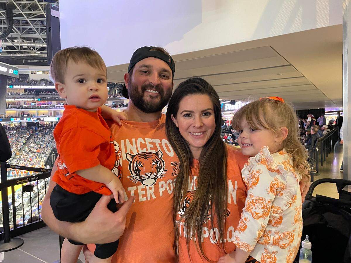 Dan and Natalie Holligan, center, pose with their two children as Princeton plays Arizona in the first round of the men’s NCAA basketball tournament on Thursday, March 16, 2023. The family drove from Walnut Creek, California to watch Dan’s alma mater take down the No. 2-seeded Wildcats, 59-55.