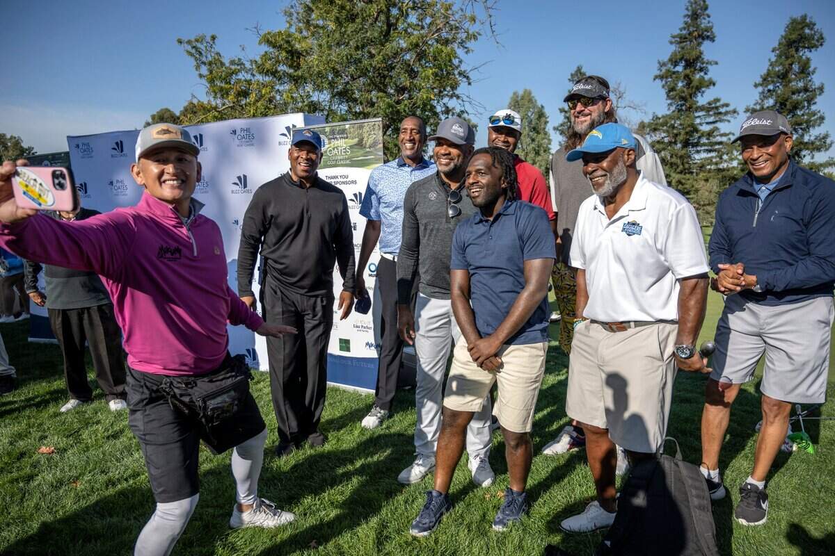 Mikuni chef-restaurateur Taro Arai takes a selfie with a group mostly composed of former NFL and NBA players, from left to right, Mike Merriweather, Harold Pressley, Derek Fisher, comedian Lance Woods, Kenny Thomas, Brad Miller, Pete Shaw and Ronnie Lott, during the Phil Oates Celebrity Golf Classic at North Ridge Country Club in Fair Oaks on Monday. The event raised more than $400,000 for charities in the Sacramento area according to Phil Oates, a real estate developer and minority owner of the Sacramento Kings.