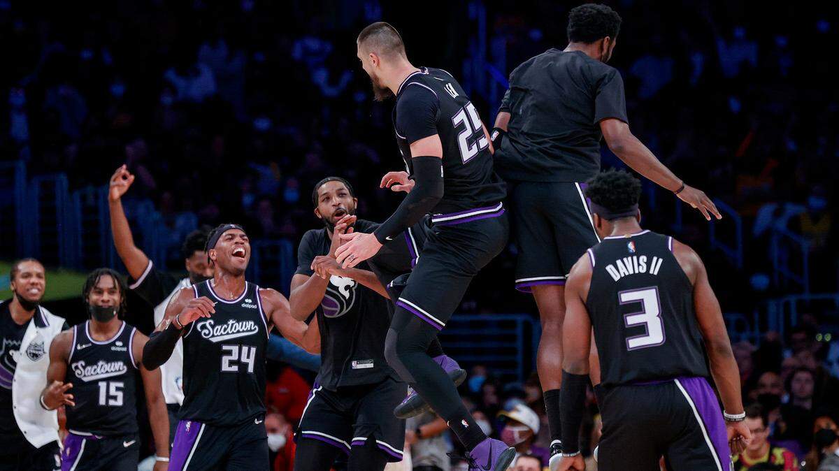 Sacramento Kings center Alex Len (25) celebrates with teammates after scoring a 3-pointer against the Los Angeles Lakers during the second half of an NBA basketball game in Los Angeles, Friday, Nov. 26, 2021. The Kings won 141-137 in triple overtime. (AP Photo/Ringo H.W. Chiu)