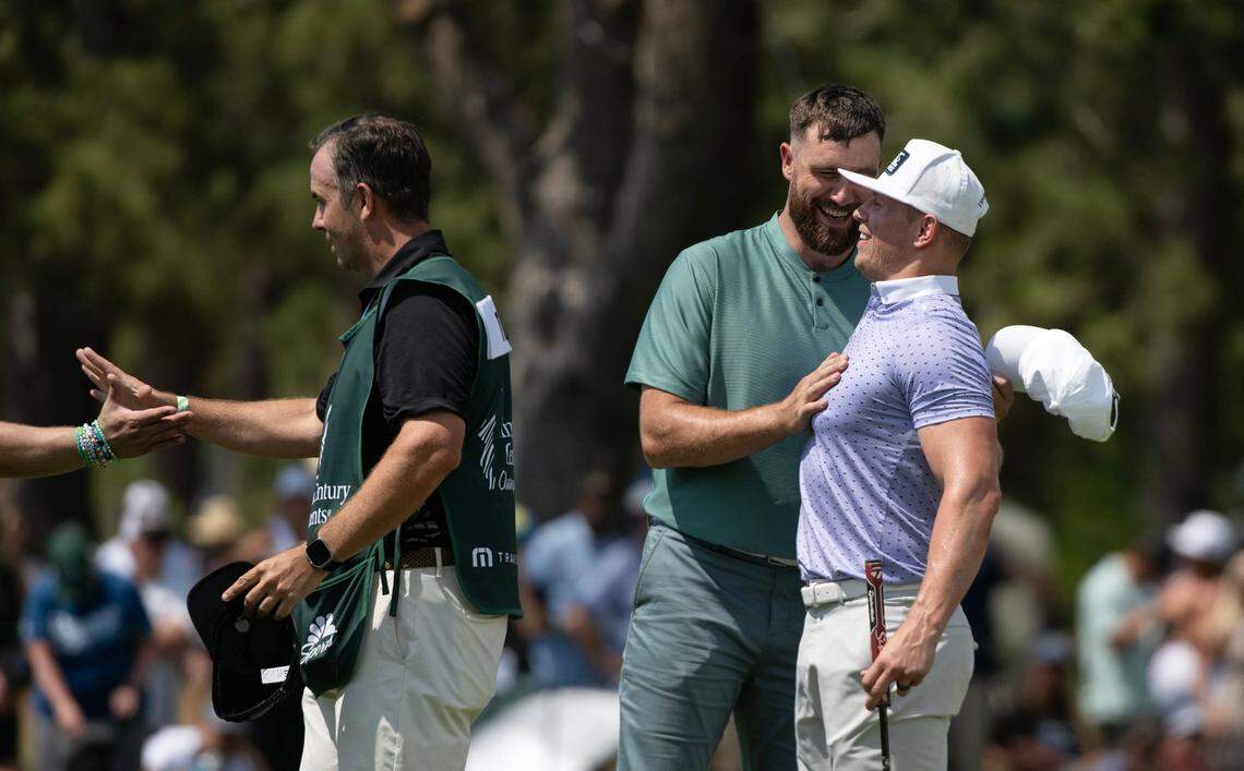 Travis Kelce embraces wrestling star Mike “The Miz” Mizanin, his playing partner, following the first round of the American Century celebrity golf championship on Friday, July 12, 2024, in Stateline, Nev.