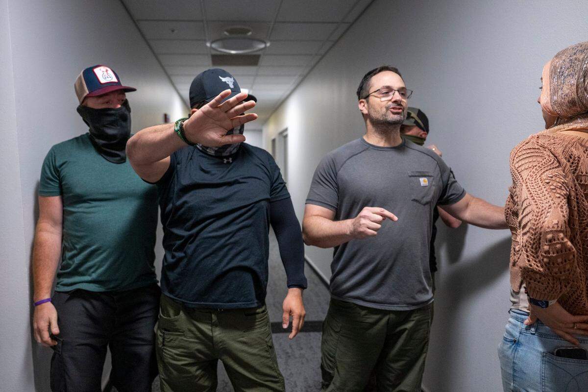 Federal authorities prevent a court observer from following a man led away by government agents after appearing in immigration court in June at the John E. Moss federal building in downtown Sacramento. A new state law requires law enforcement officers to wear identification when working when they aren’t wearing uniforms. 