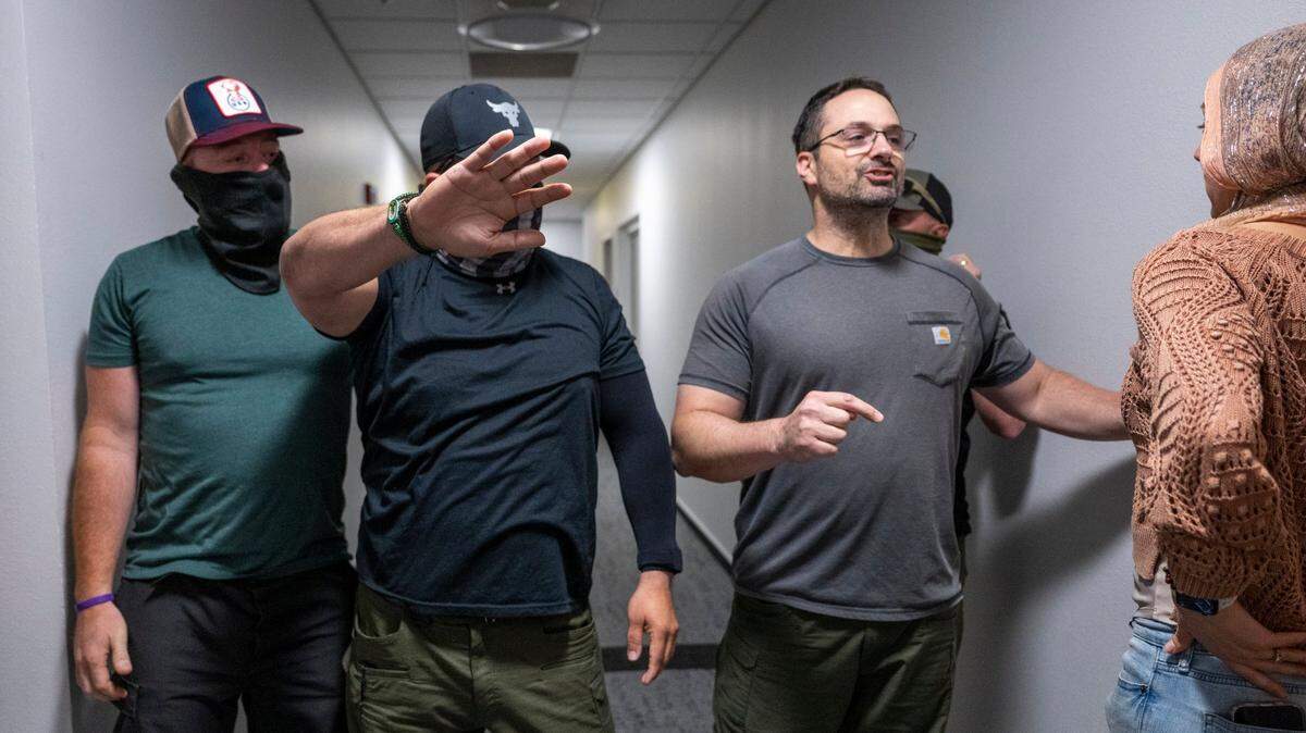 Federal authorities prevent an court observer from following a man led away by government agents after appearing in immigration court on Thursday, June 12 2025, in the John E. Moss federal building in downtown Sacramento.