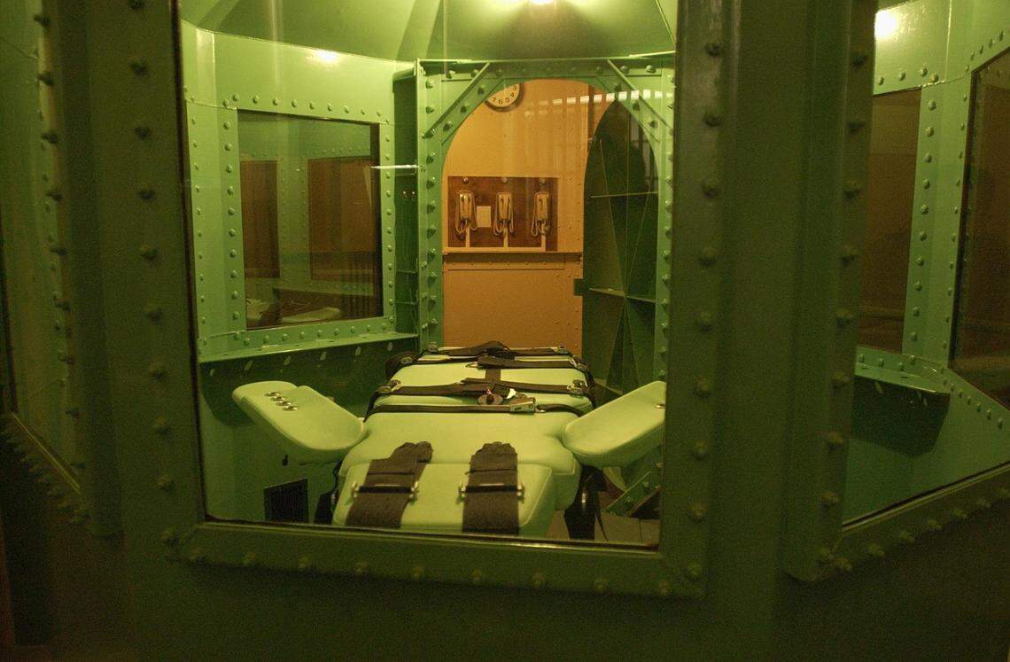 The phones to stop an execution hang on the wall in the background near the execution chamber of San Quentin Prison, Friday June 20, 2003. 