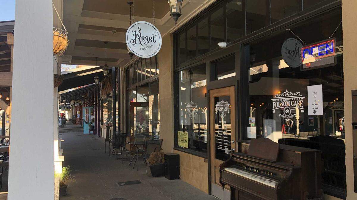The exterior of The Folsom Cafe, which changed its name from “Reset: Cafe by Day” in January, the sign of which can still be seen out front, photographed on Monday, Feb. 13, 2023. Customers can help themselves to a full coffee bar, tea, wine, beer, pastries and sandwiches.