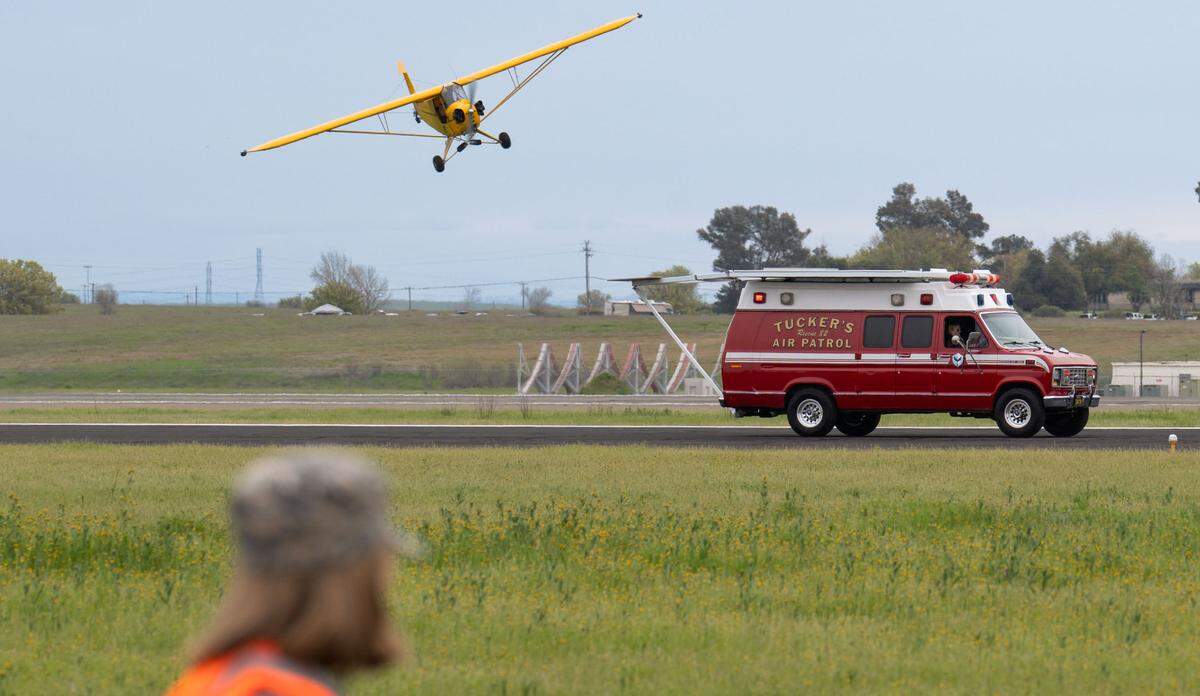 Eric Tucker lands his 1941 J3 Cub on the top of an ambulance driving down the runway at the California Capital Airshow at Mather Airport on Saturday, March 22, 2025.