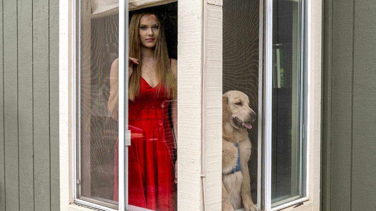 Riley Flynn, 16, of Rocklin, was posing in her prom dress when her dog Barley decided to join in on Wednesday, March 18, 2020. High school proms and senior balls were canceled at that point in the coronavirus pandemic.