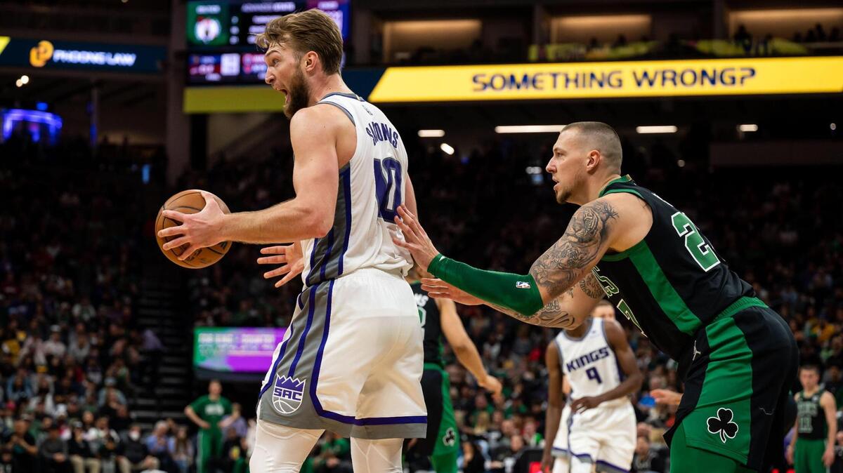 Sacramento Kings forward Domantas Sabonis (10) looks to officials for a call after pulling in an offensive rebound, as Boston Celtics center Daniel Theis (27) defends closely, during the second half of the NBA basketball game Friday, March 18, 2022, at Golden 1 Center in Sacramento.