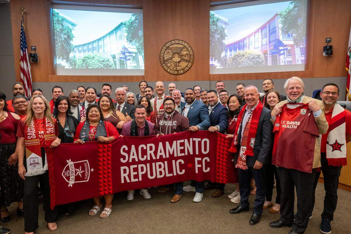 Sacramento Mayor Kevin McCarty, City Council members and other members of the community pose for a photo with the Sacramento Republic FC on Tuesday after the approval of two resolutions that will allow construction of a Railyards soccer stadium.