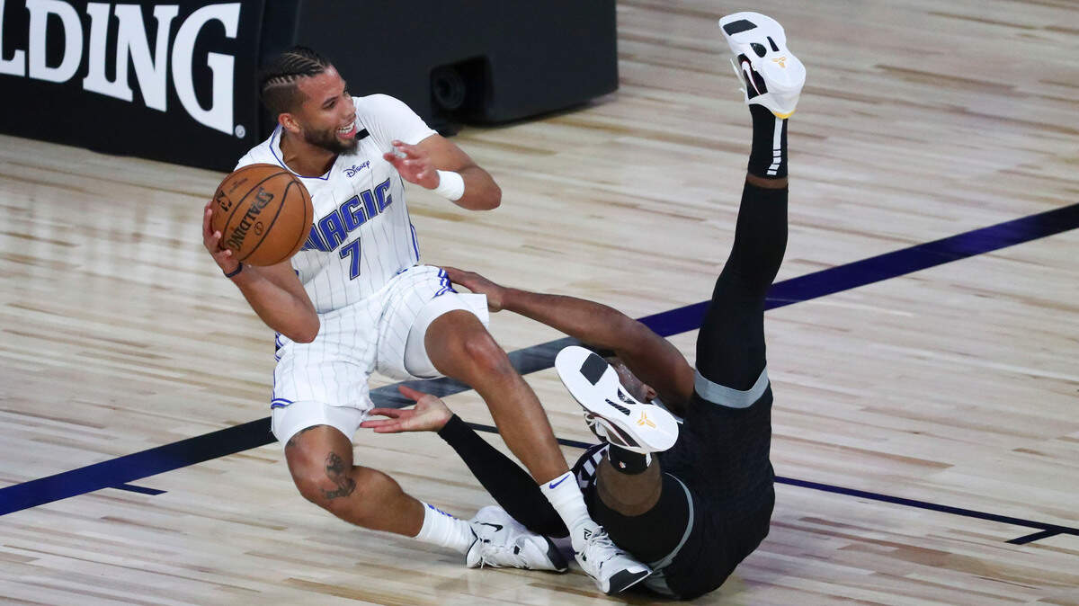 Orlando Magic guard Michael Carter-Williams is defended by Sacramento Kings guard Buddy Hield on Sunday.