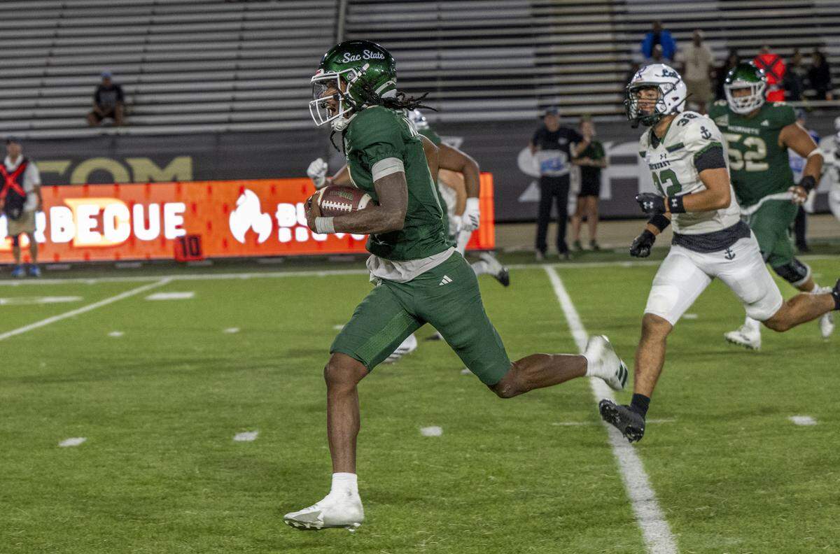 Sacramento State Hornets quarterback Cardell Williams (7) runs in for the final touchdown during an NCAA football game against the Mercyhurst Lakers on Saturday at Hornet Stadium.