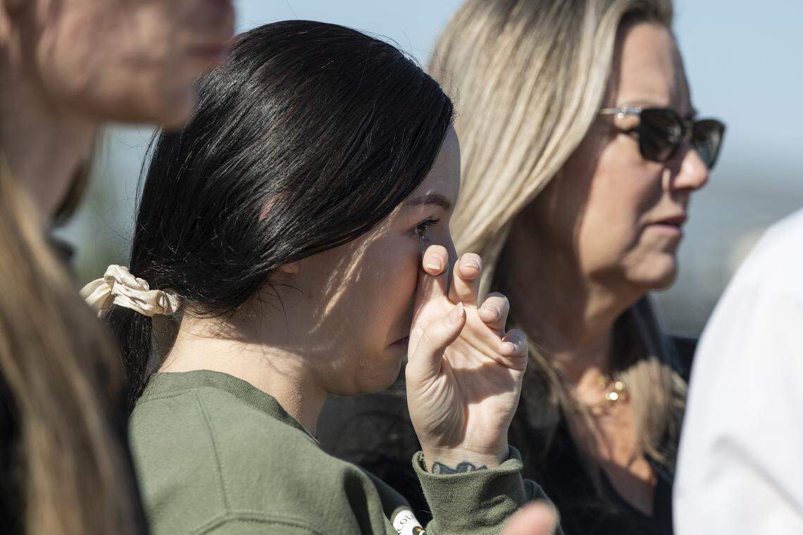 Krista Juels wipes a tear as she watches the unveiling of a sign dedicating a portion of Interstate 80 to her cousin, Marine Sgt. Nicole Gee, in Roseville on Wednesday. Gee, a Roseville native, was killed during the U.S. withdrawal from Afghanistan in 2021.