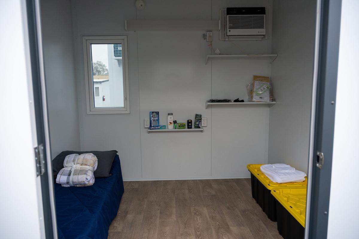 A view inside a tiny home at the north campus of Sacramento's Roseville Road homeless shelter, to be operated by The Gathering Inn, shows a cot, two storage bins and an individual heating and air-conditioning system on Thursday. Half of the units will allow pets.