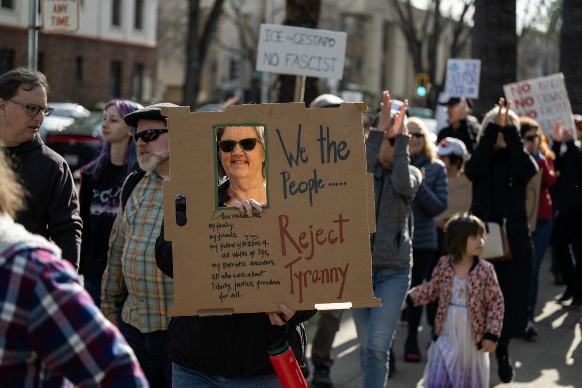 Protesters march from Capitol Park to Memorial Auditorium in Sacramento during an “ICE Out For Good” demonstration on Saturday.