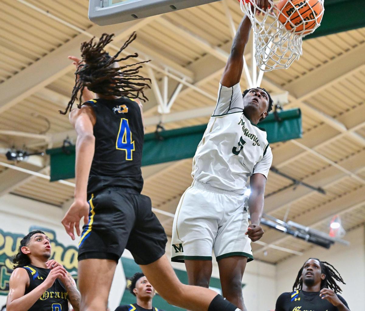 Monterey Trail Mustangs guard Brandon Gibson (5) dunks on the Grant Pacers’ Isaiah Montue (4) in January in Elk Grove. Gibson is The Bee’s Boys Basketball Player of the Year.