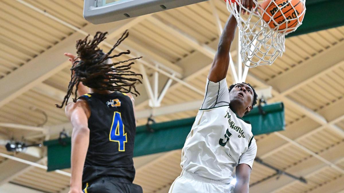 Monterey Trail Mustangs Brandon Gibson Jr (5) dunks on Grant Pacers Isaiah Montue (4) during the second half of the game on Jan. 10 at Monterey Trail High School in Elk Grove. Gibson Jr. was the top-scorer with 31 points.