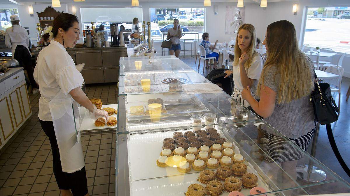 Sunghee Kang, left, helps customers Lyuda Klymets of Washington, and Dina Ustymchuk of Sacramento at Estelle's patisseries on Arden Way in Sacramento on Tuesday, June 12, 2018. 