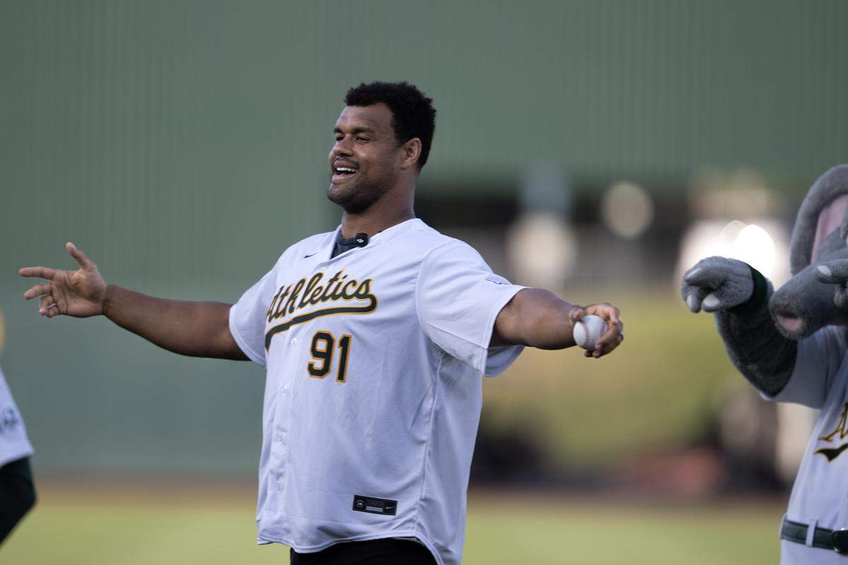 Arik Armstead of the Jacksonville Jaguars reacts after throwing out the ceremonial first pitch before the Athletics played the San Francisco Giants on Friday at Sutter Health Park in West Sacramento.