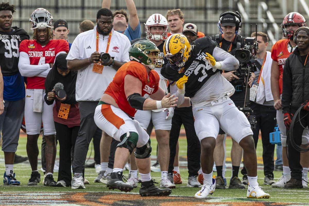 Jan 29, 2025; Mobile, AL, USA; American team offensive lineman Jackson Slater of Sacramento State (67) battles American team defensive lineman Sai'vion Jones of LSU (34) during Senior Bowl practice for the American team at Hancock Whitney Stadium. Mandatory Credit: Vasha Hunt-Imagn Images