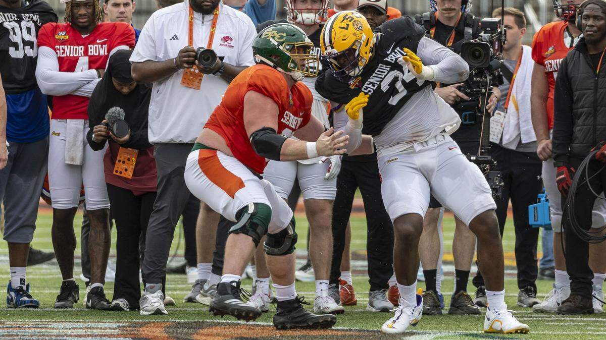 Jan 29, 2025; Mobile, AL, USA; American team offensive lineman Jackson Slater of Sacramento State (67) battles American team defensive lineman Sai'vion Jones of LSU (34) during Senior Bowl practice for the American team at Hancock Whitney Stadium. Mandatory Credit: Vasha Hunt-Imagn Images
