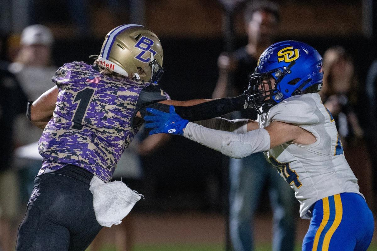 The Sutter Huskies’ Colton Martinez (24) tries to bring down the Bradshaw Christian Pride’s Nathan Zeppieri (1) in the first half on Friday.