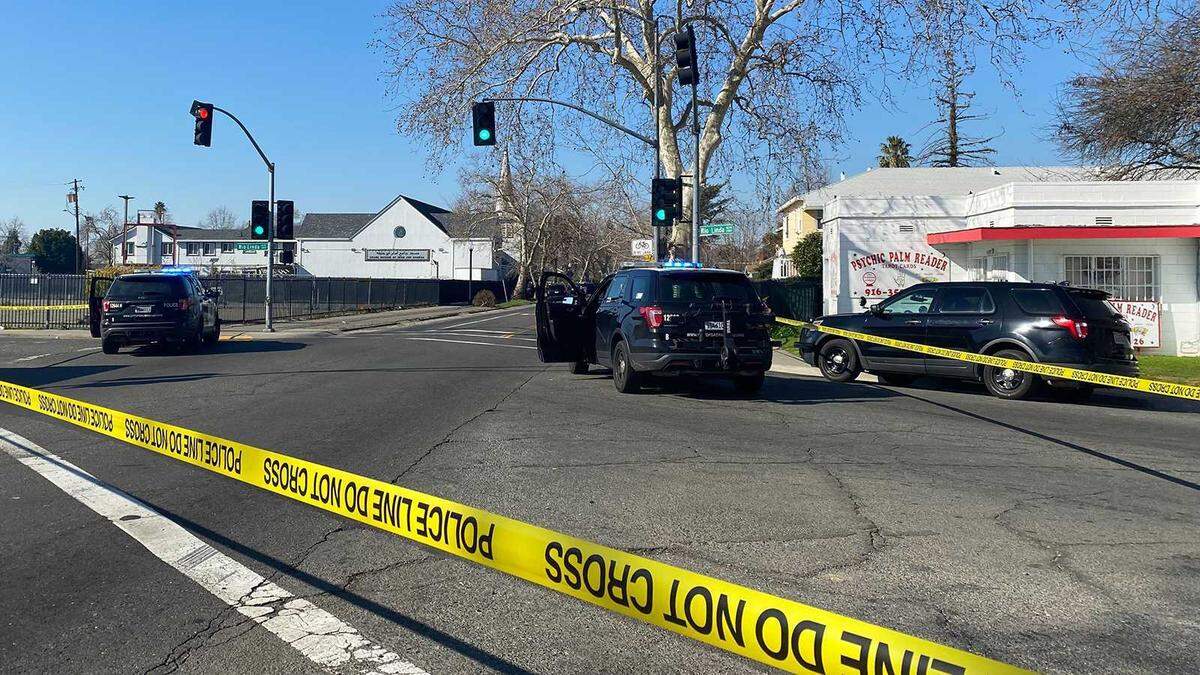 Police tape and vehicles block Rio Linda Boulevard at El Camino Avenue on Thursday, Feb. 9, 2023, following a shooting involving an officer in North Sacramento, Calif.