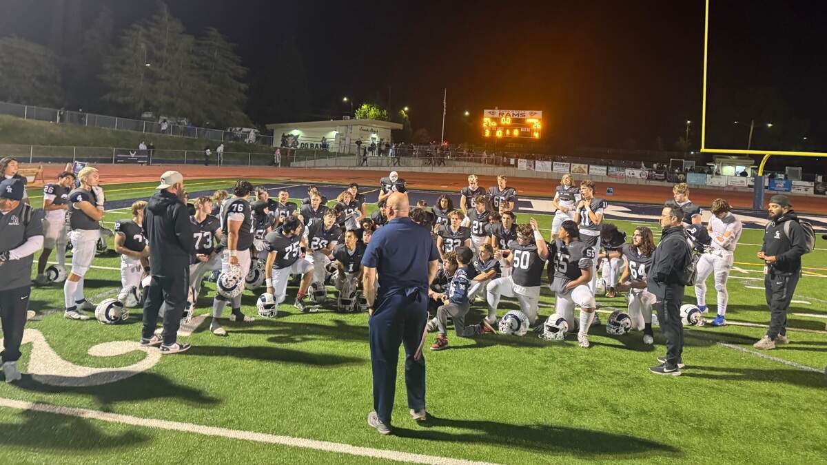 Casa Roble coach Chris Horner addresses his team after the Rams beat Foothill 27-26 in a Division V playoff opener Friday in Orangevale.