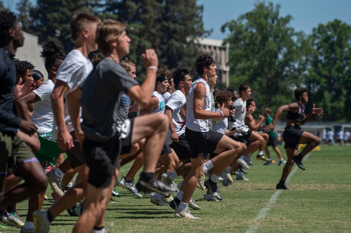 High school football players run a drill during a skills camp at Sacramento State under the eye of college coaches from across the country on Wednesday.