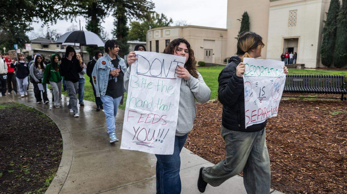 McClatchy High students hold signs during a school walk-out on Thursday morning, Feb. 6, 2025, to protest President Donald Trump’s executive orders. 