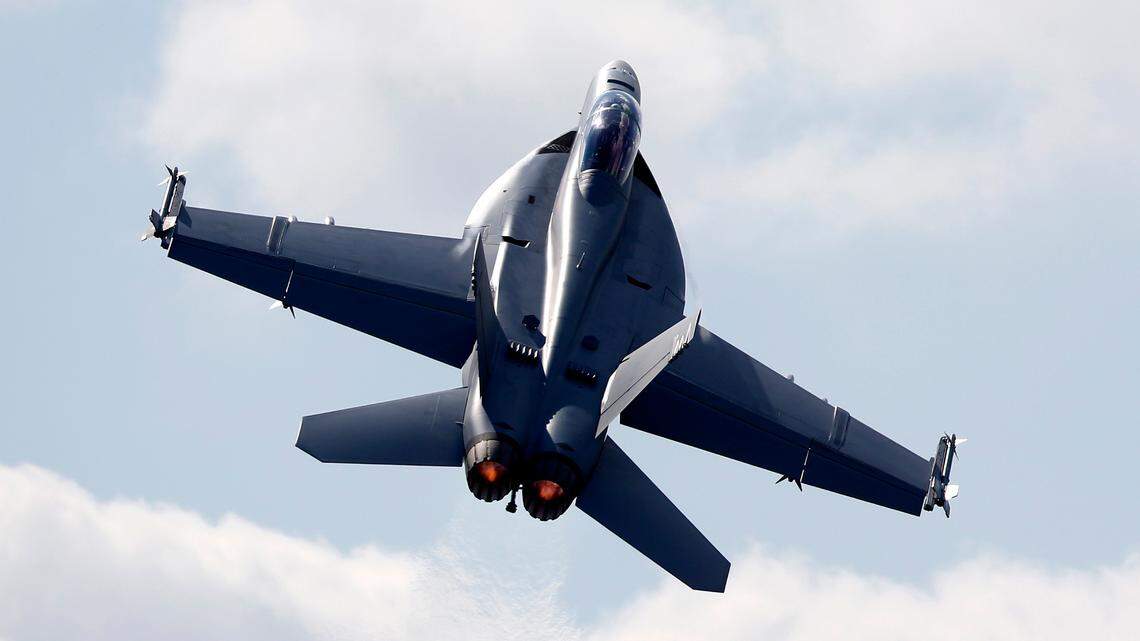A Boeing F/A-18 E/F Super Hornet flies on display during the Farnborough International Air Show, Farnborough, England, on Tuesday, July 15, 2014. The California Highway Patrol confirmed a Navy fighter jet crashed near Naval Air Weapons Station China Lake. (AP Photo/Sang Tan)