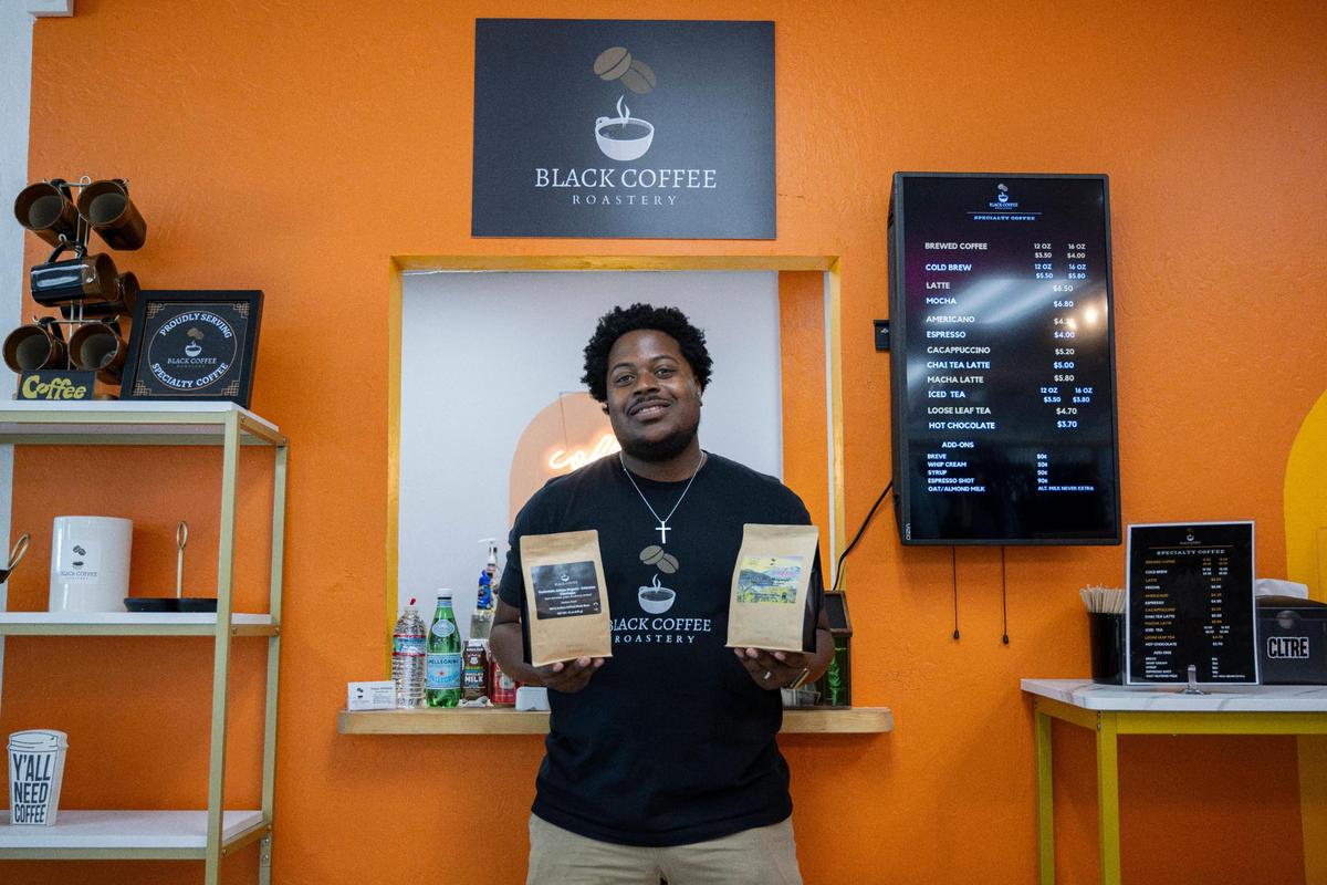 Black Coffee Roastery owner Dante Williams holds some of his products on Aug. 3 at CLTRE Club, a Sacramento venue that helps new business owners establish a brick-and-mortar location.
