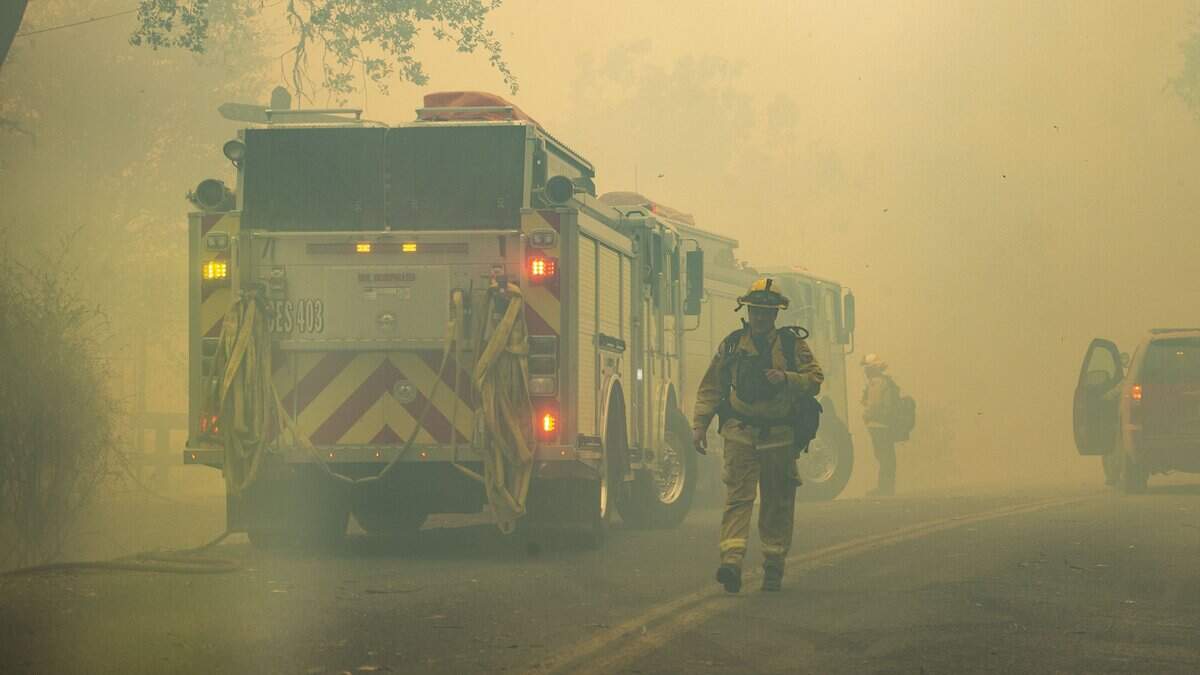 Firefighters prepare to move out as the Kincade Fire in Sonoma County makes its way down Chalk Hill Road in Healdsburg Sunday, Oct. 27, 2019.