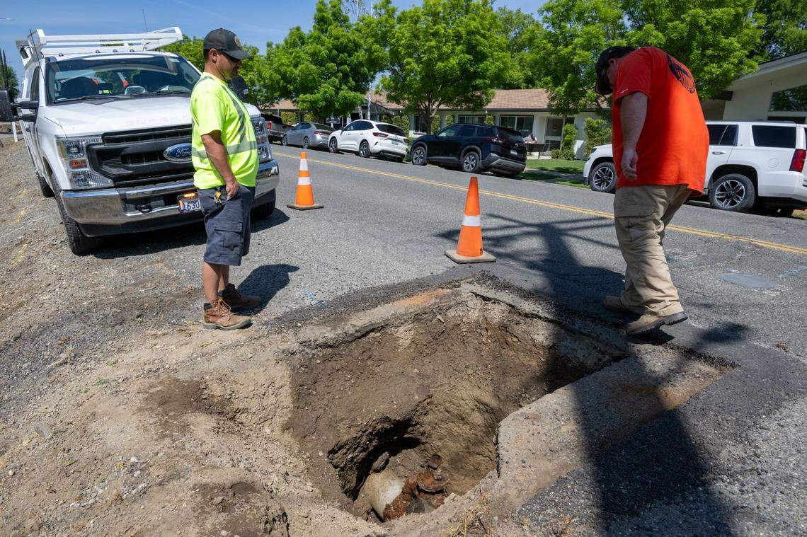 Bobby Alvernaz, superintendent of Public Works in Williams, right, looks over a corroded 3-inch galvanized pipe attached to the 11-inch water main that needs replacement on E Street, the city’s main thoroughfare, on Tuesday. The project’s federal funding was effectively killed in March, which also puts a street improvement project on hold.